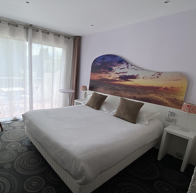 Double bed in the Tribord room at the Hotel Europe, in the Hérault
