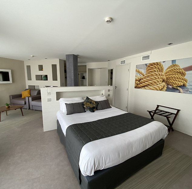 Double bed and lounge area in the Prestige suite - Hotel Europe in Hérault